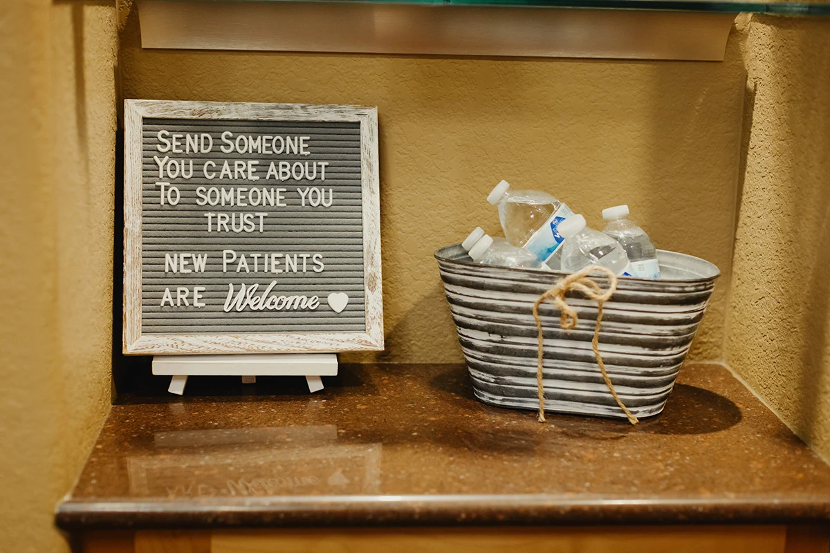 Greeley Dental Care welcomes new patients with a sign and refreshments, creating a friendly and inviting atmosphere.